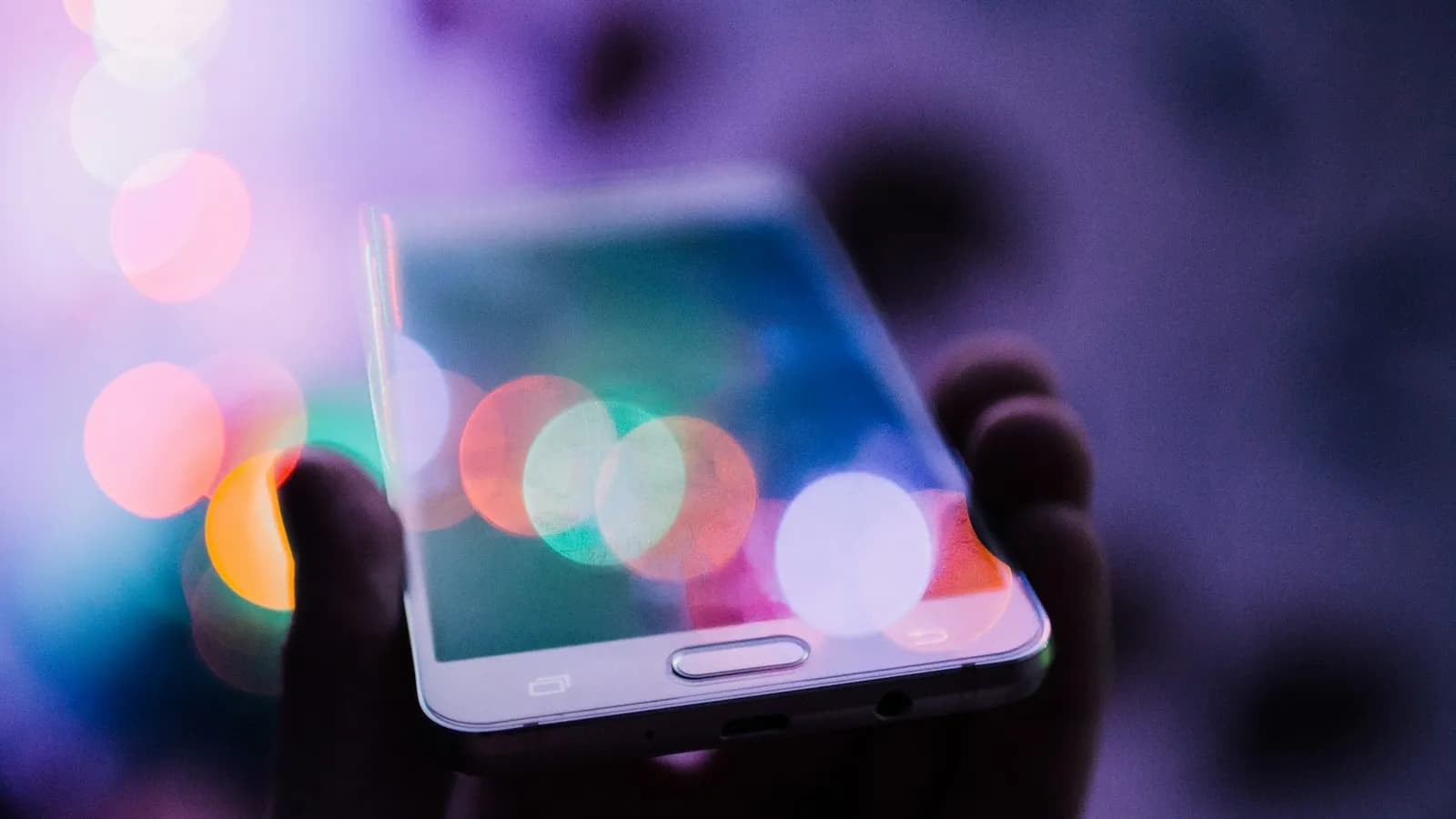 A person holding a smartphone in both hands, reading the screen