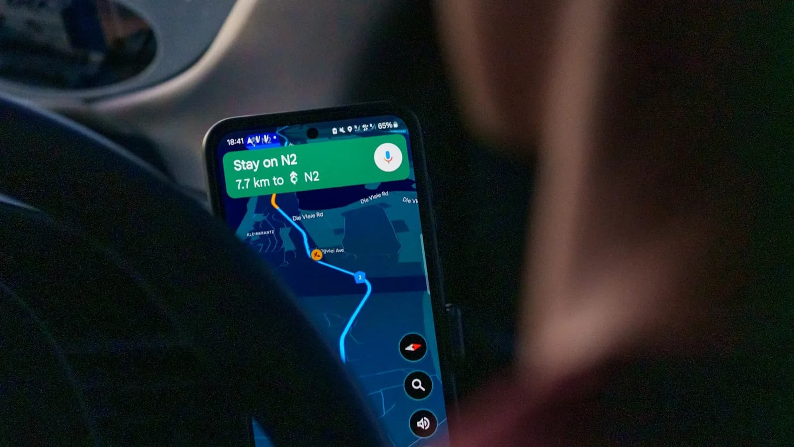 A phone mounted in a car showing a navigation map