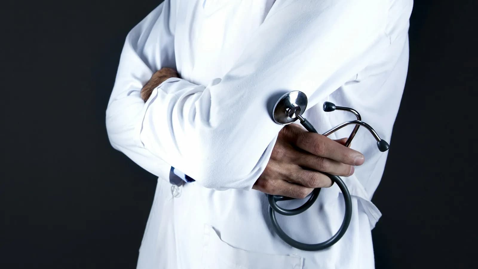 A doctor in a white coat holding a stethoscope