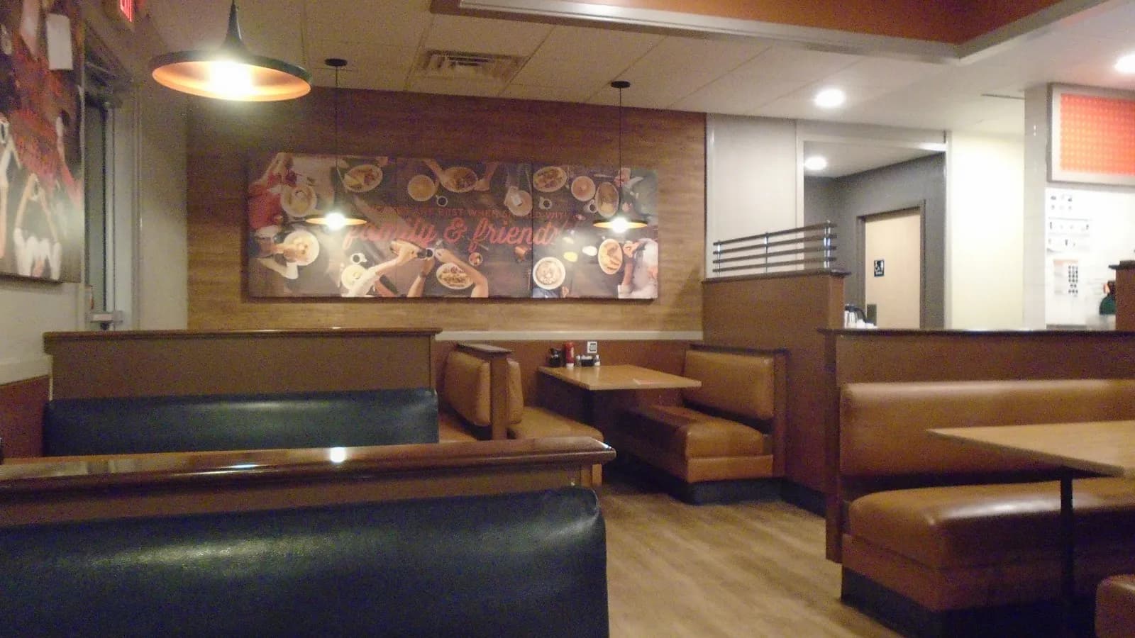 An empty restaurant dining room with booths and tables