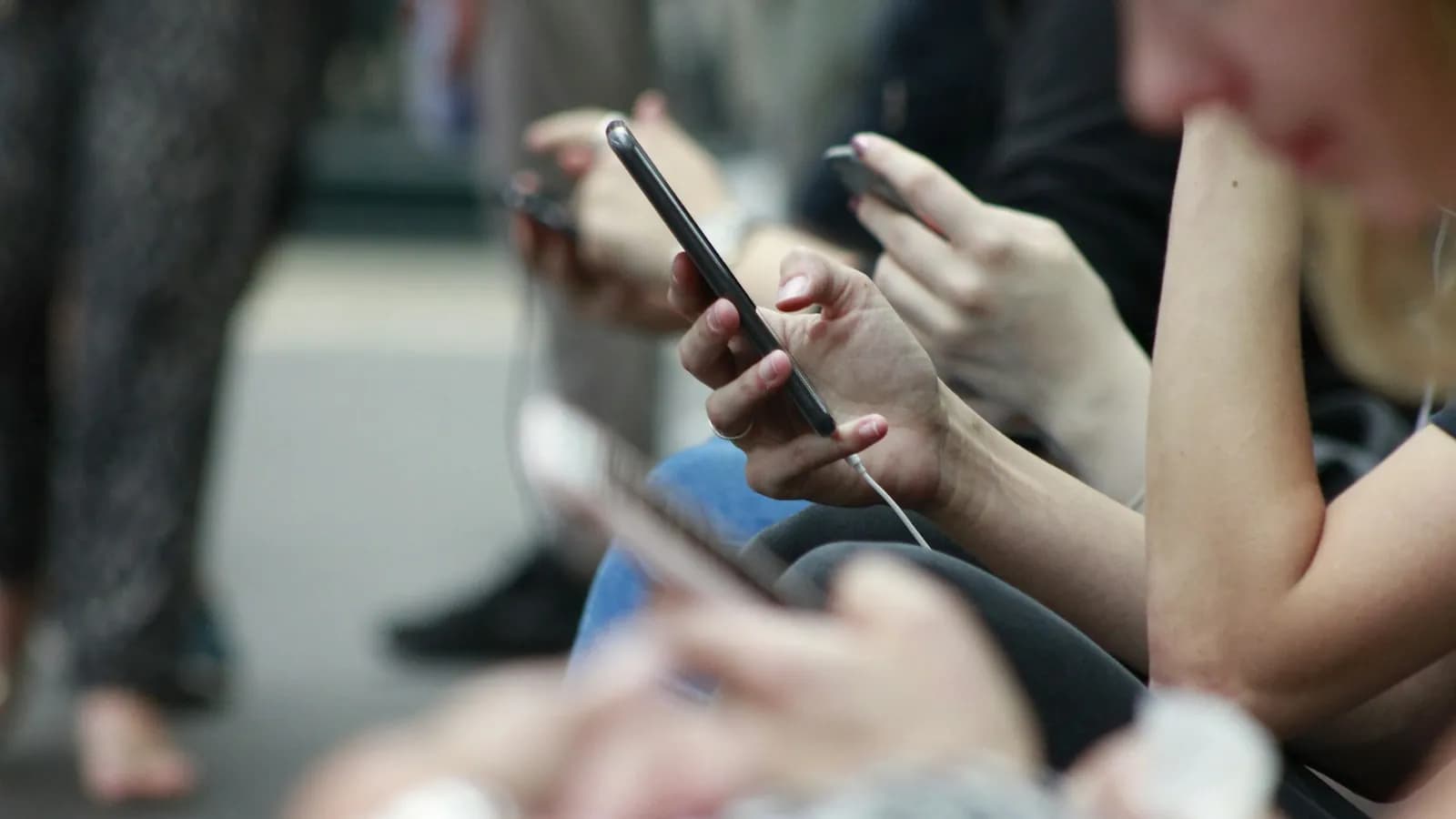 Several people looking at their smartphones